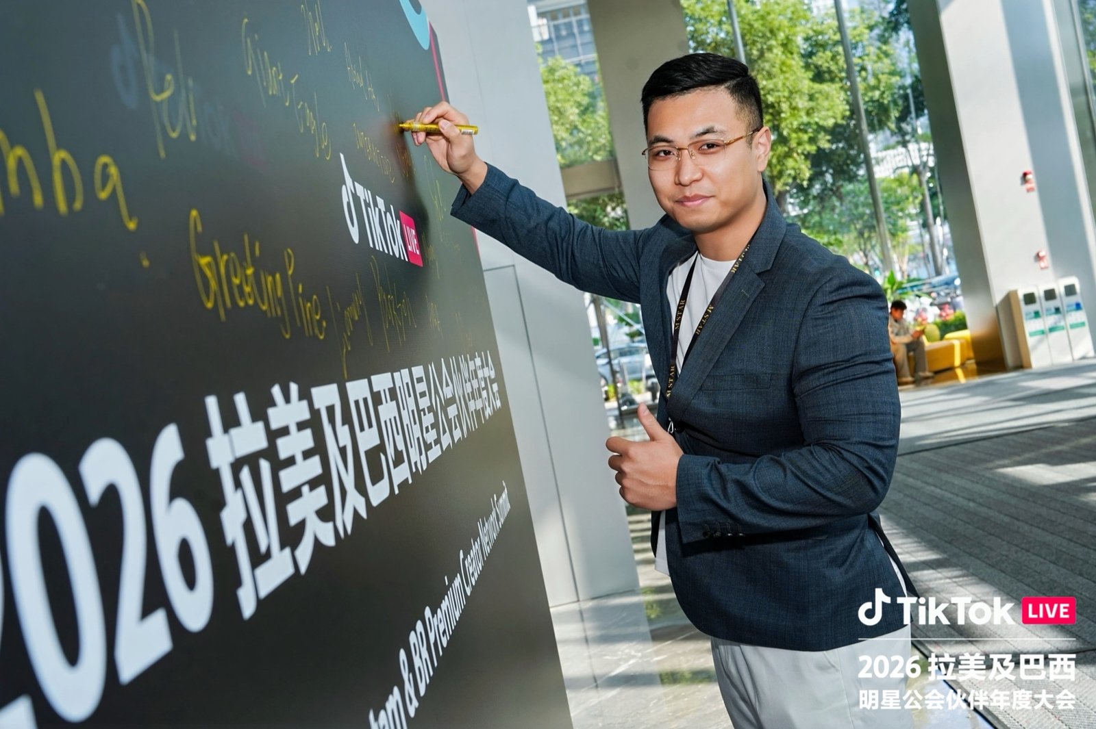 Representante de M STAR AGENCY firmando el mural de la Cumbre 2026 de TikTok LIVE.